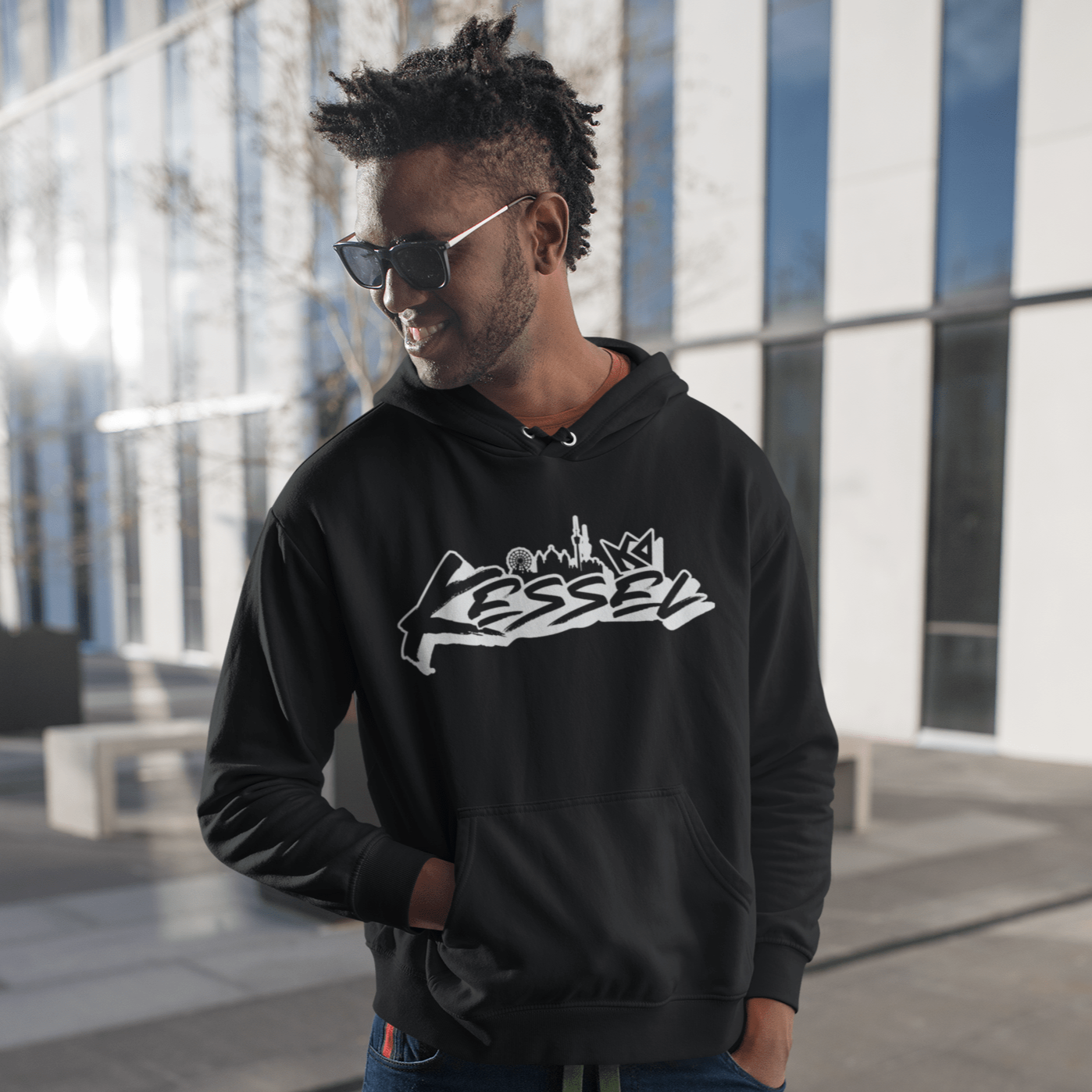 a man with dreadlocks wearing a black hoodie