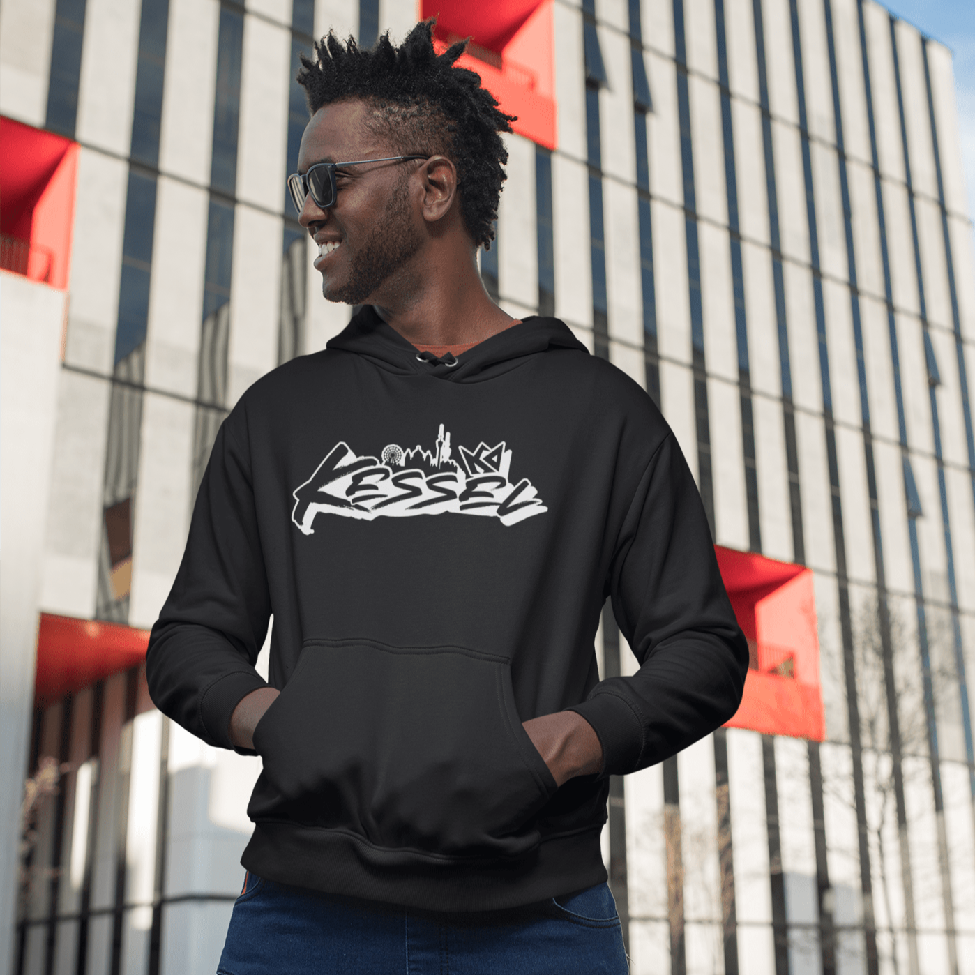 a man wearing a black hoodie with graffiti on it
